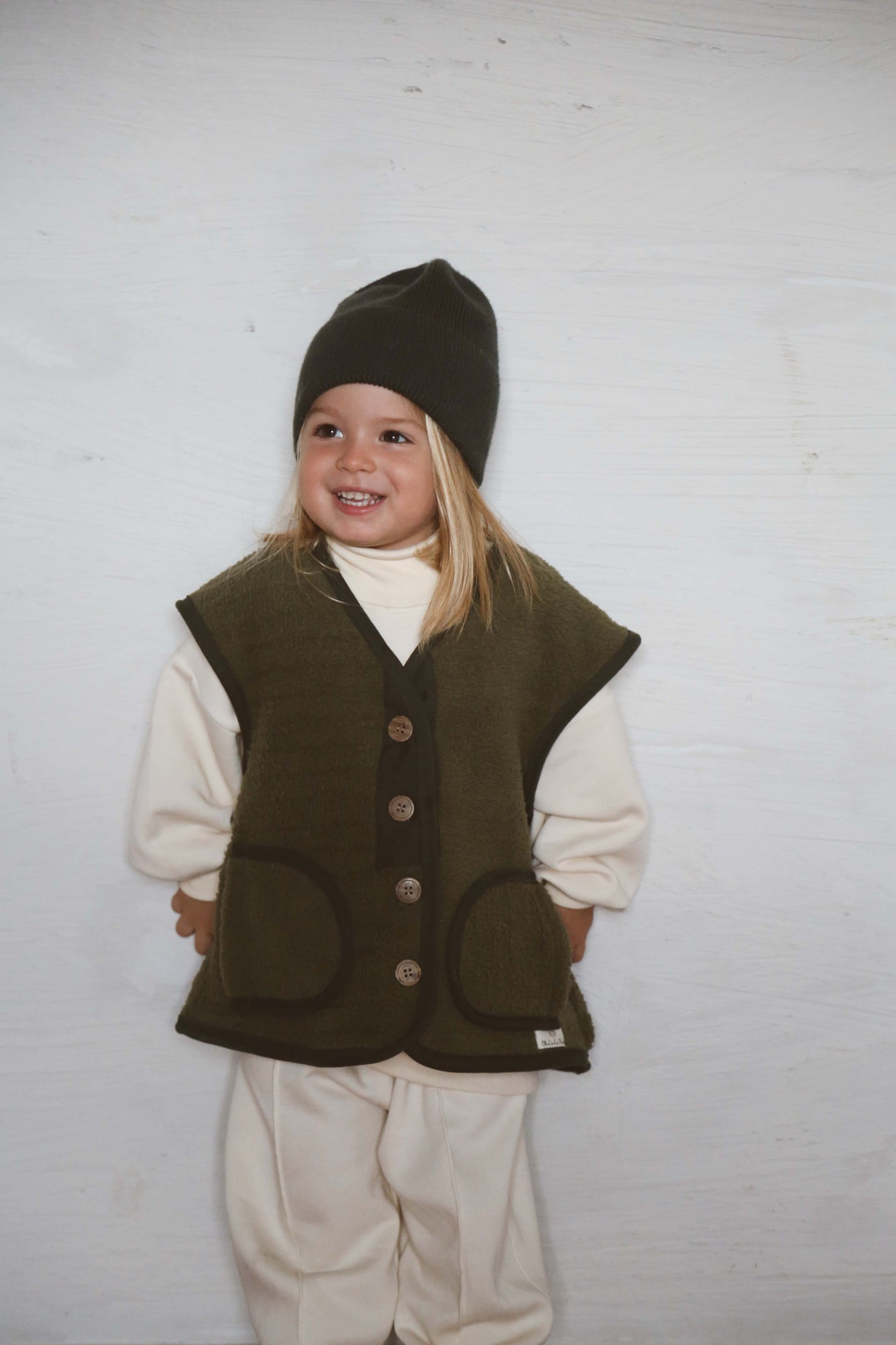 Oversized khaki green vest for kids layering piece boutique front view