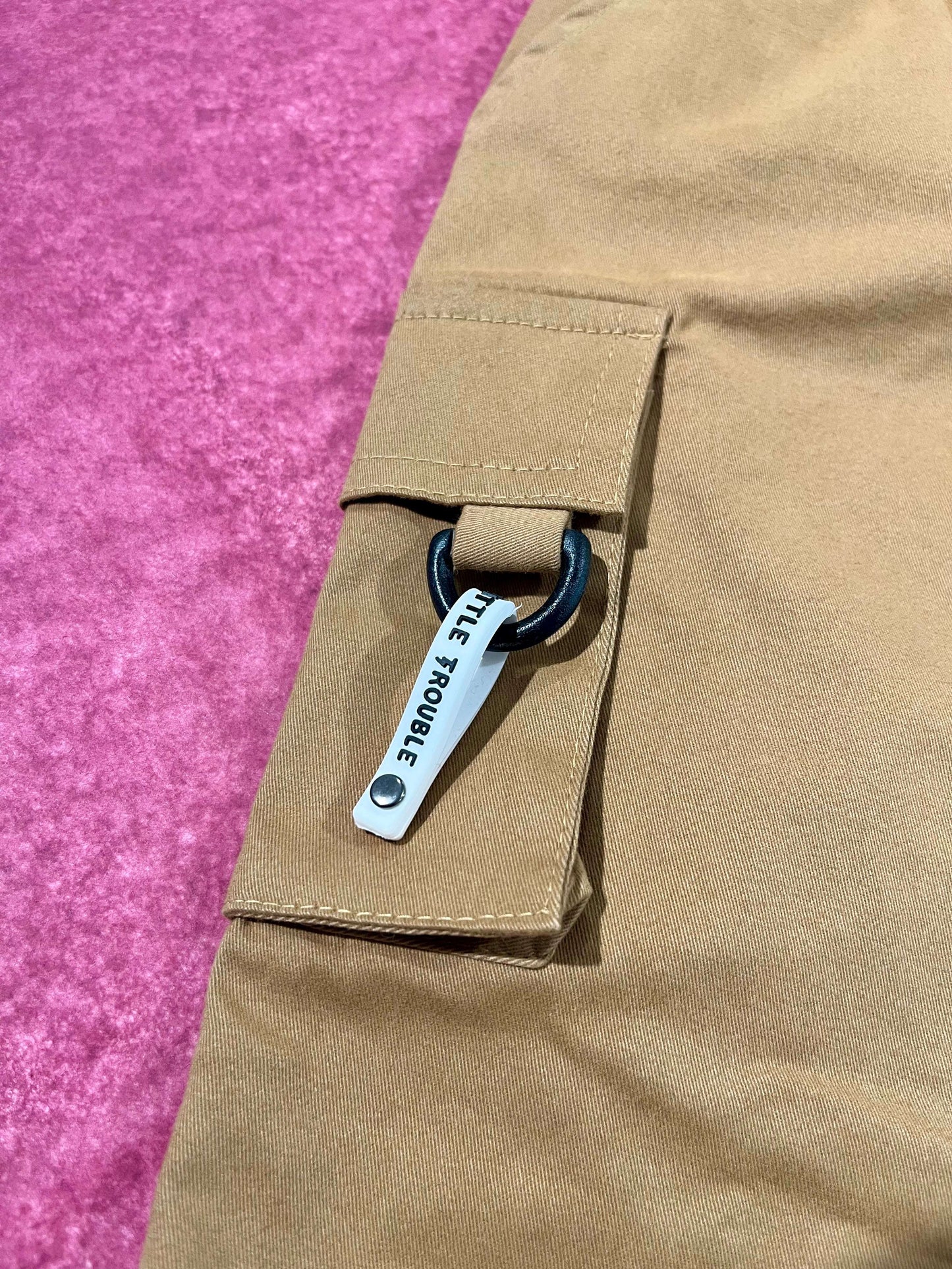 Kids cargo pants close up pocket and hardware detail