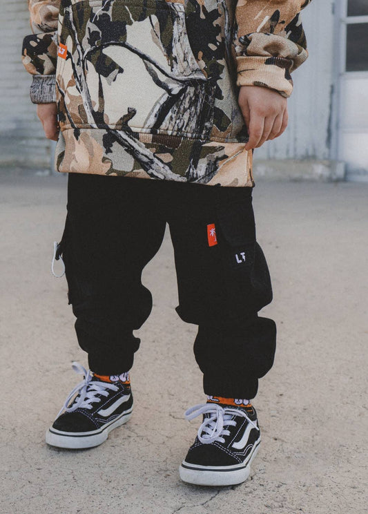 Black cargo pants for kids with functional pockets and elastic drawstring waist front view