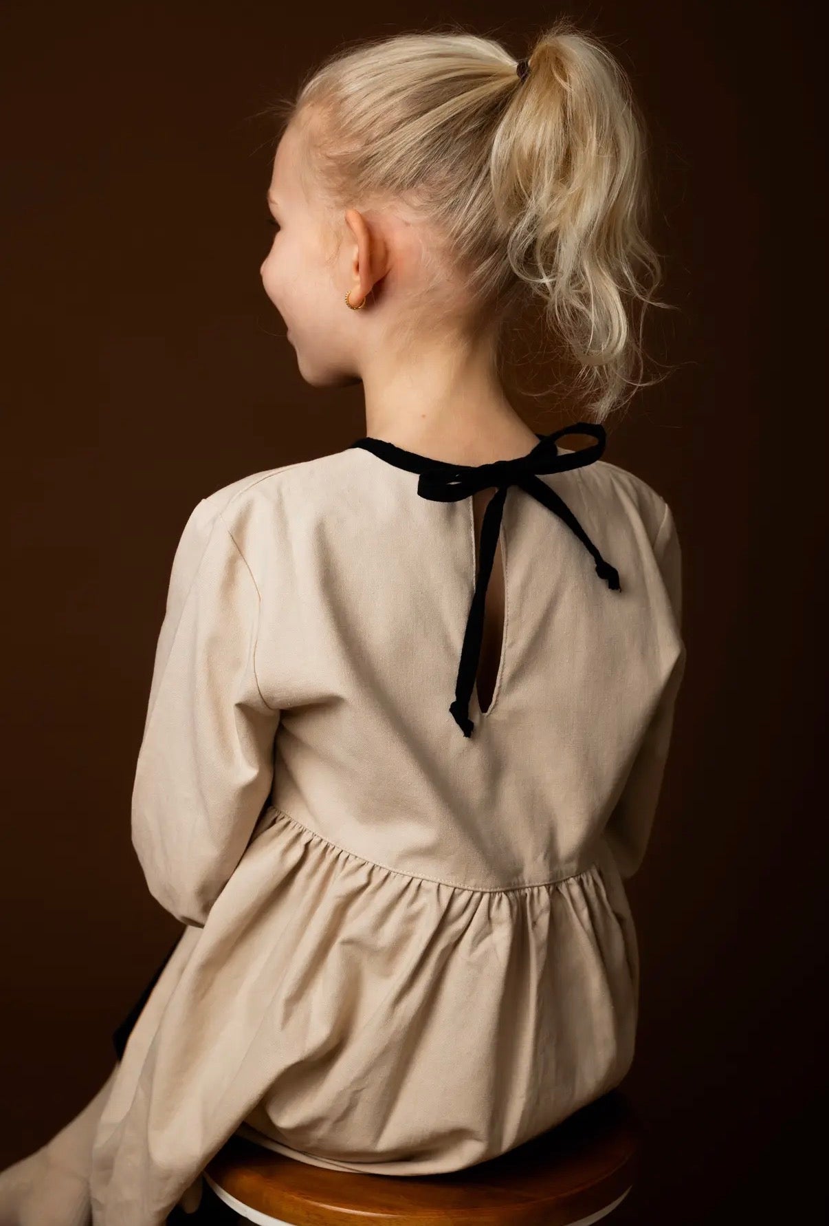 Vanilla bean toddler linen dress back view