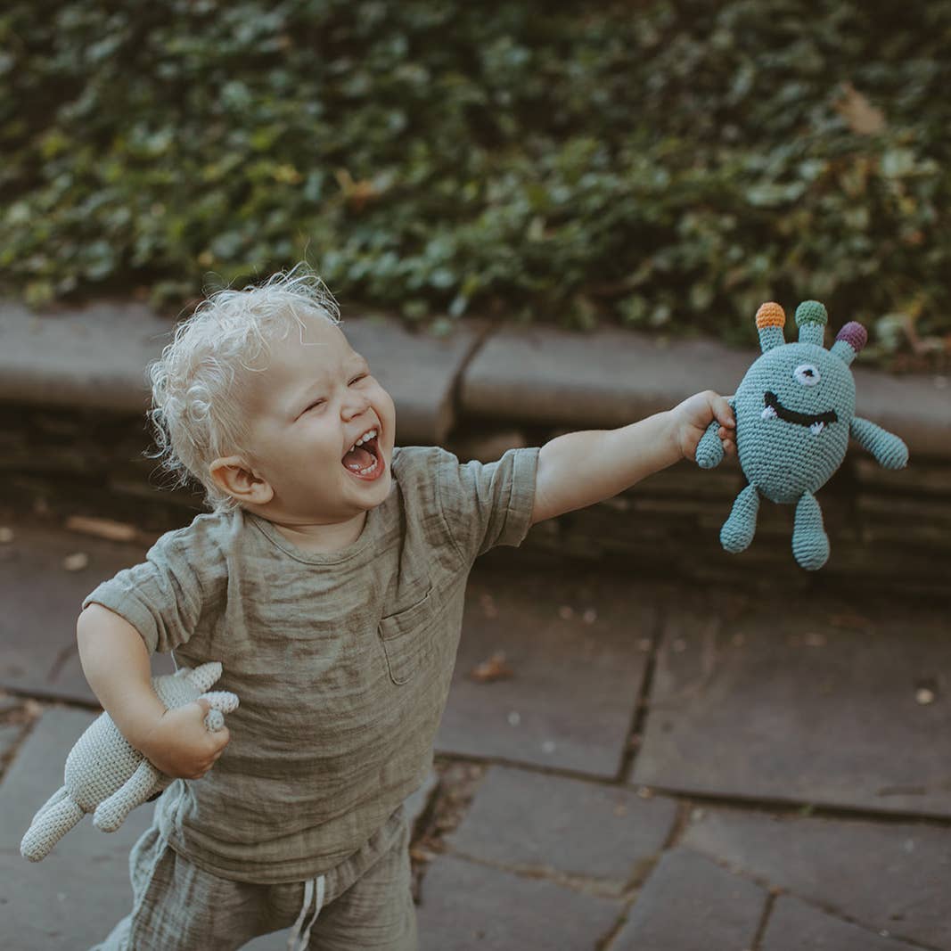 Baby organic monster rattle held lifestyle view