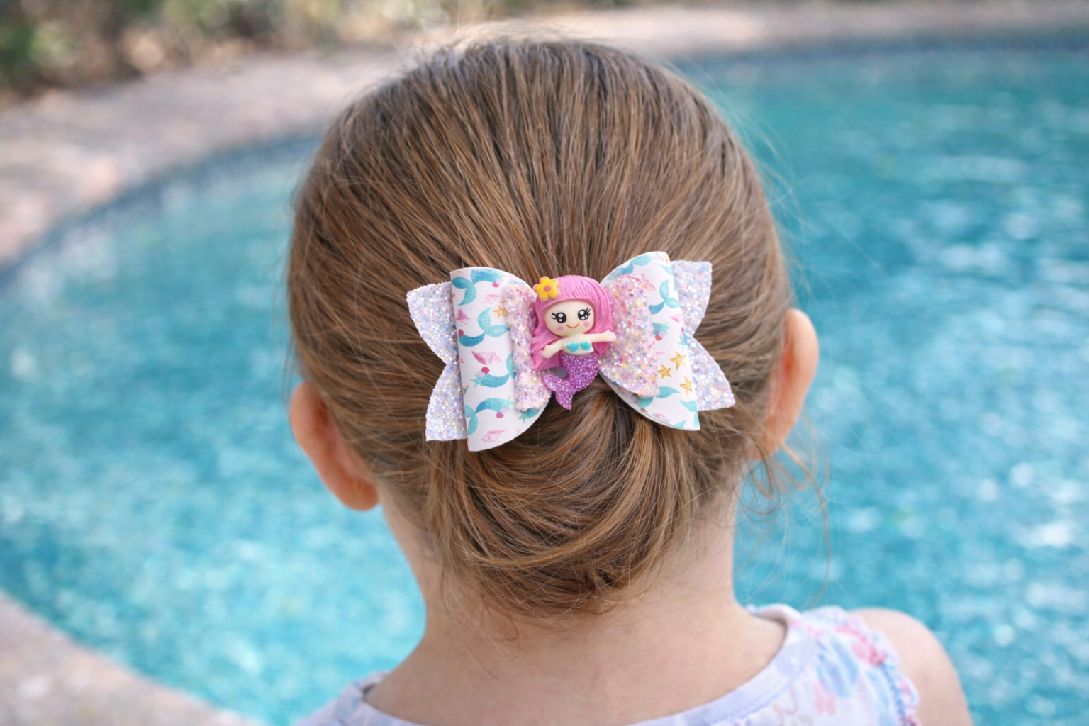 Mermaid hair bow for girls with secure alligator clip worn lifestyle shot