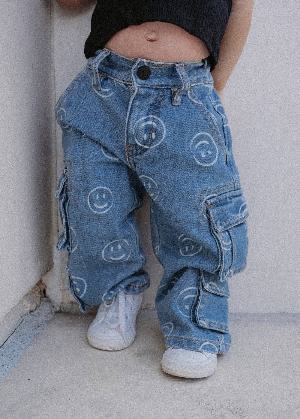 Kids relaxed baggy jeans with smiley face print and elastic waistband side view