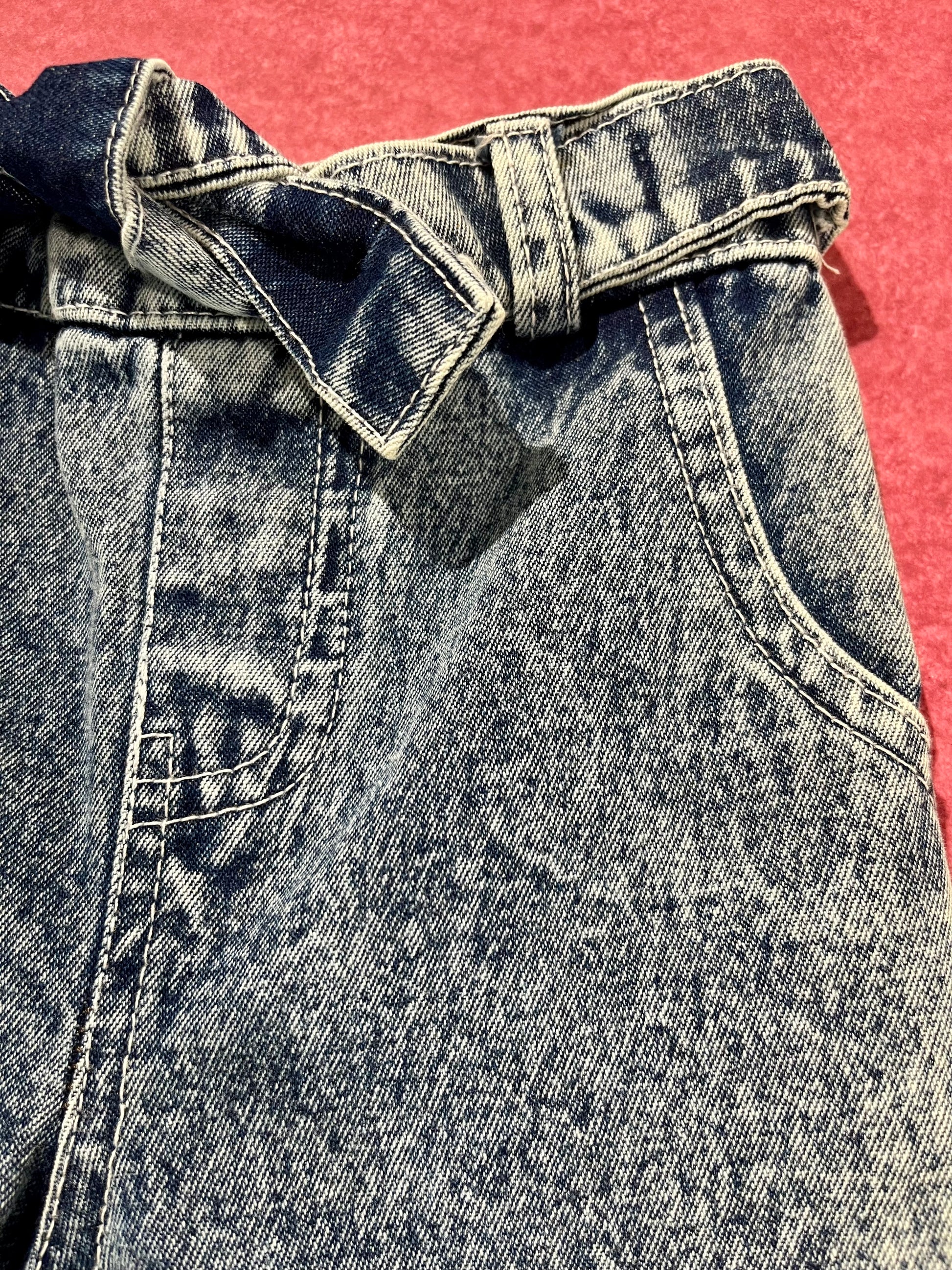 Girls boutique denim jeans close up pocket and waistband detail