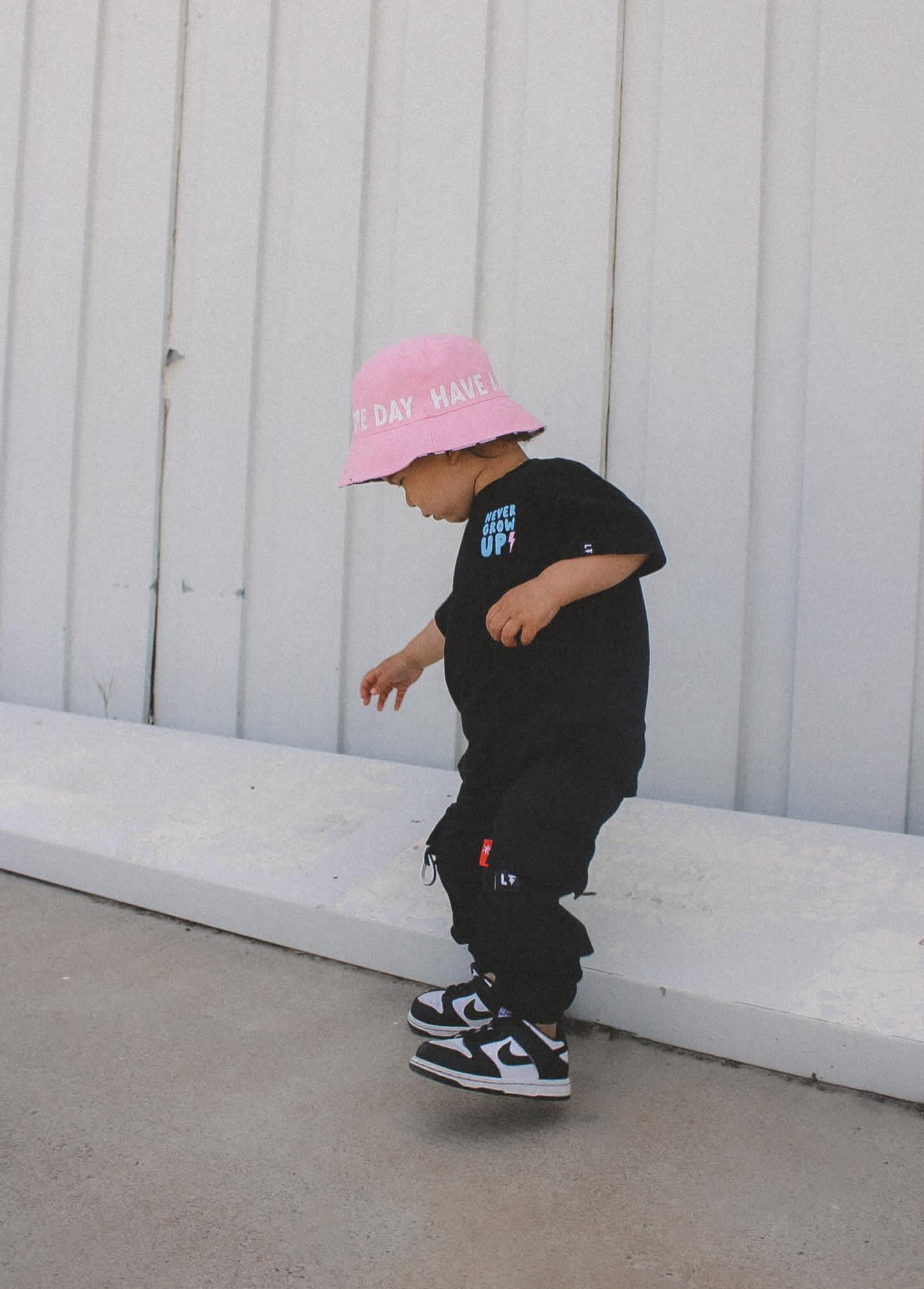 Black kids boutique cargo pants worn full length outfit styling view