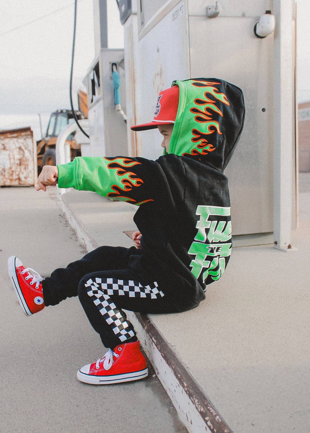 Fuel the Fun green flame hoodie for kids in black with bold green sleeve flames front view