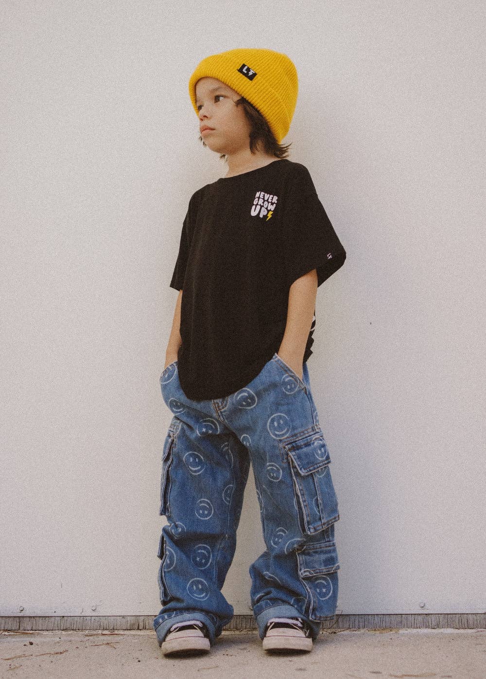 Boys soft stretchy denim smiley face jeans with double cargo pockets detail view