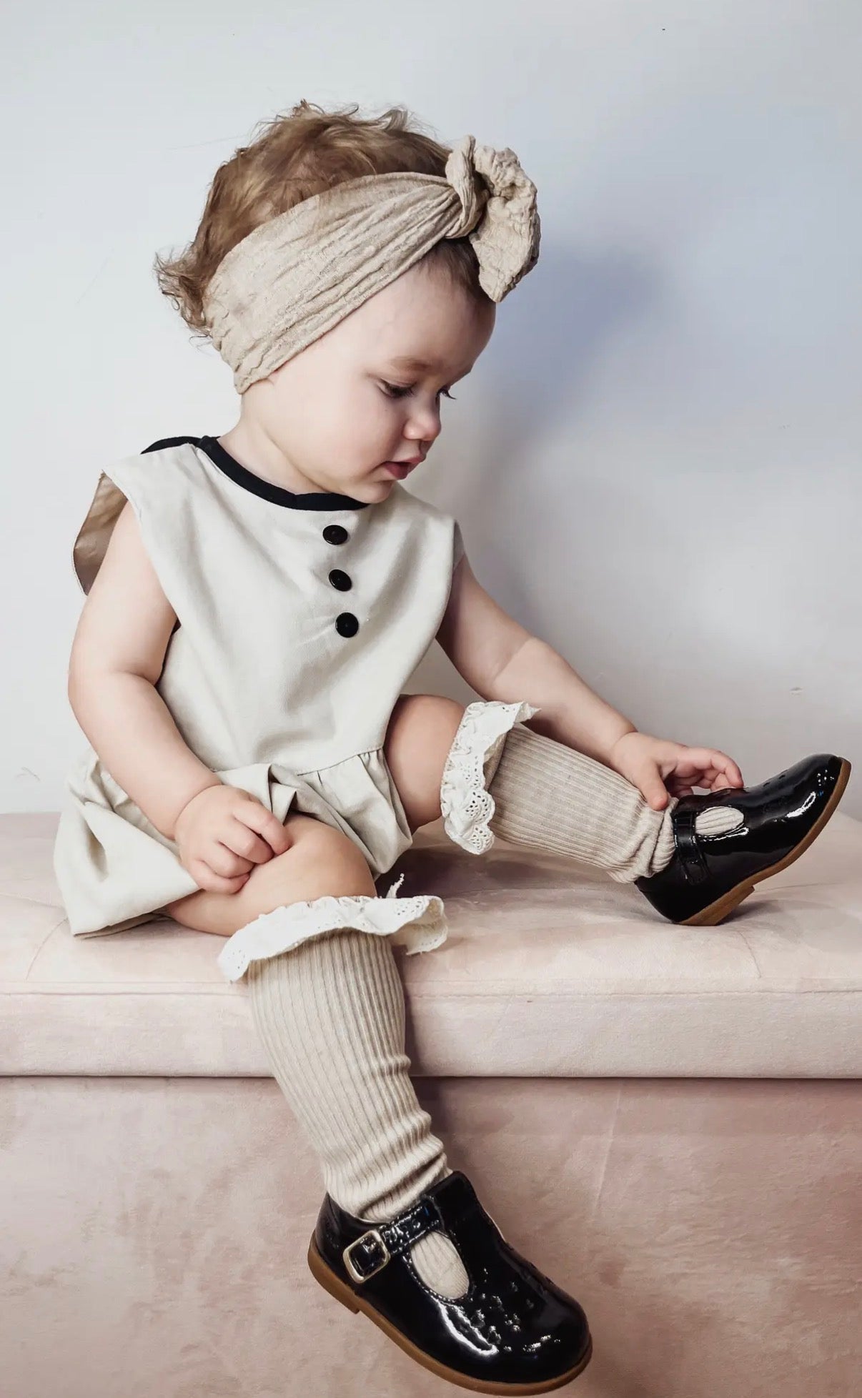 Baby vanilla bean linen romper worn lifestyle view