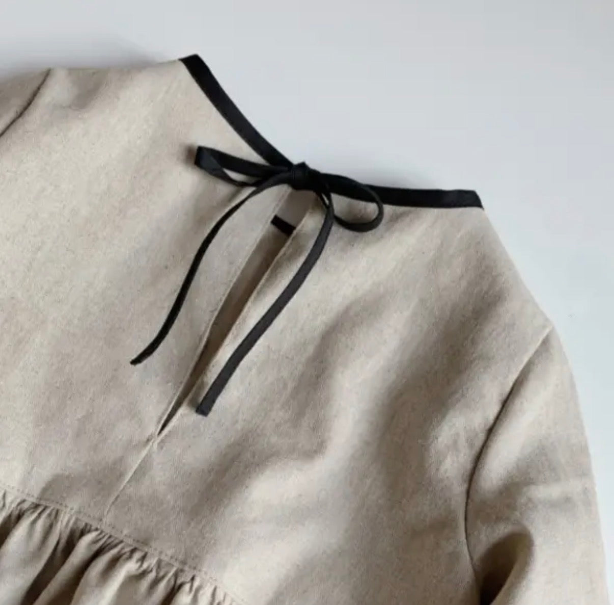 Baby vanilla bean linen dress flat lay product view