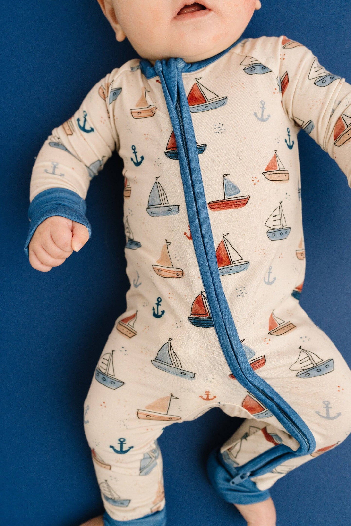 Baby nautical sleeper with fold over footies and mittens worn lifestyle shot