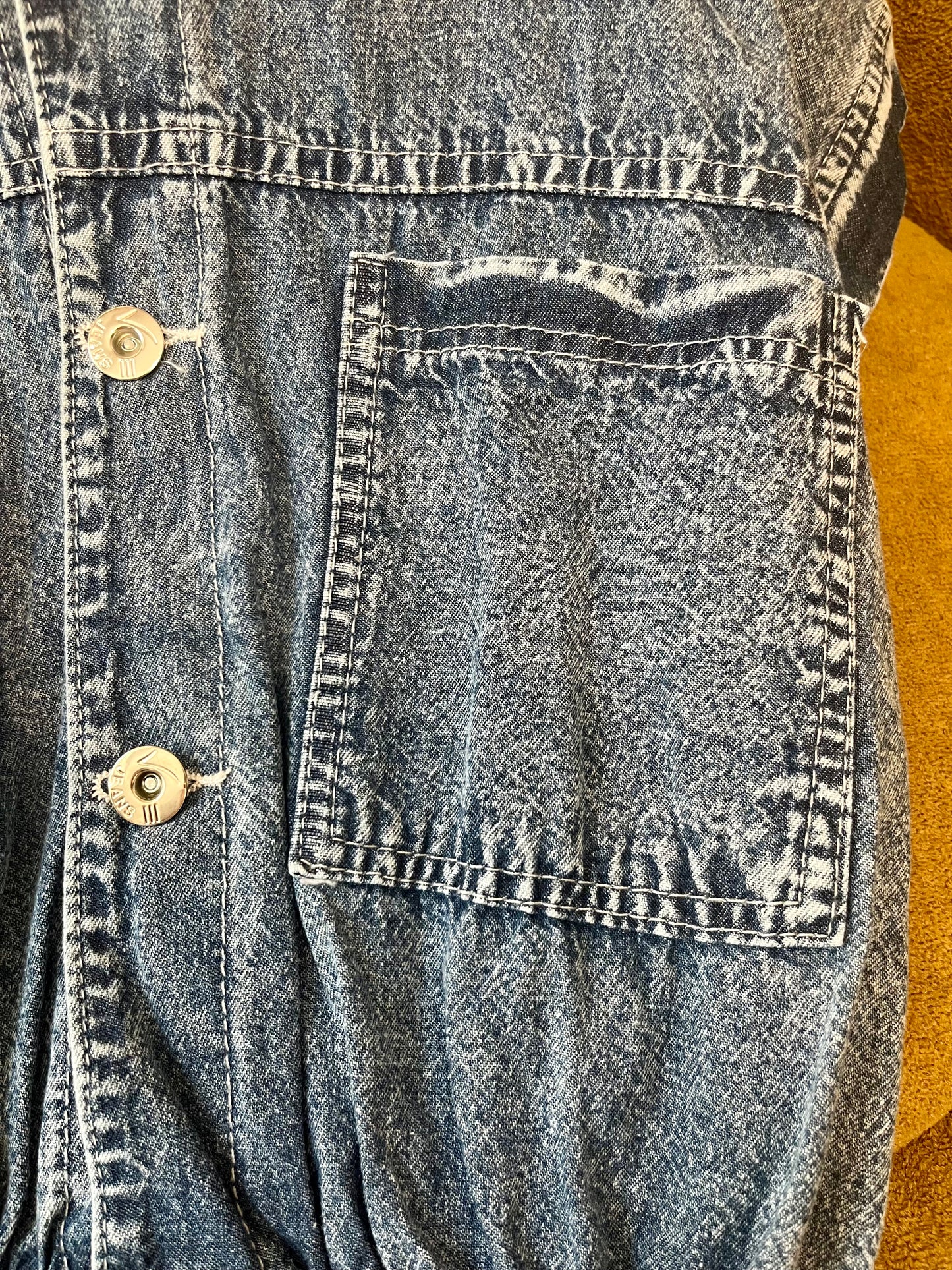 Kids denim top close up fabric and button detail
