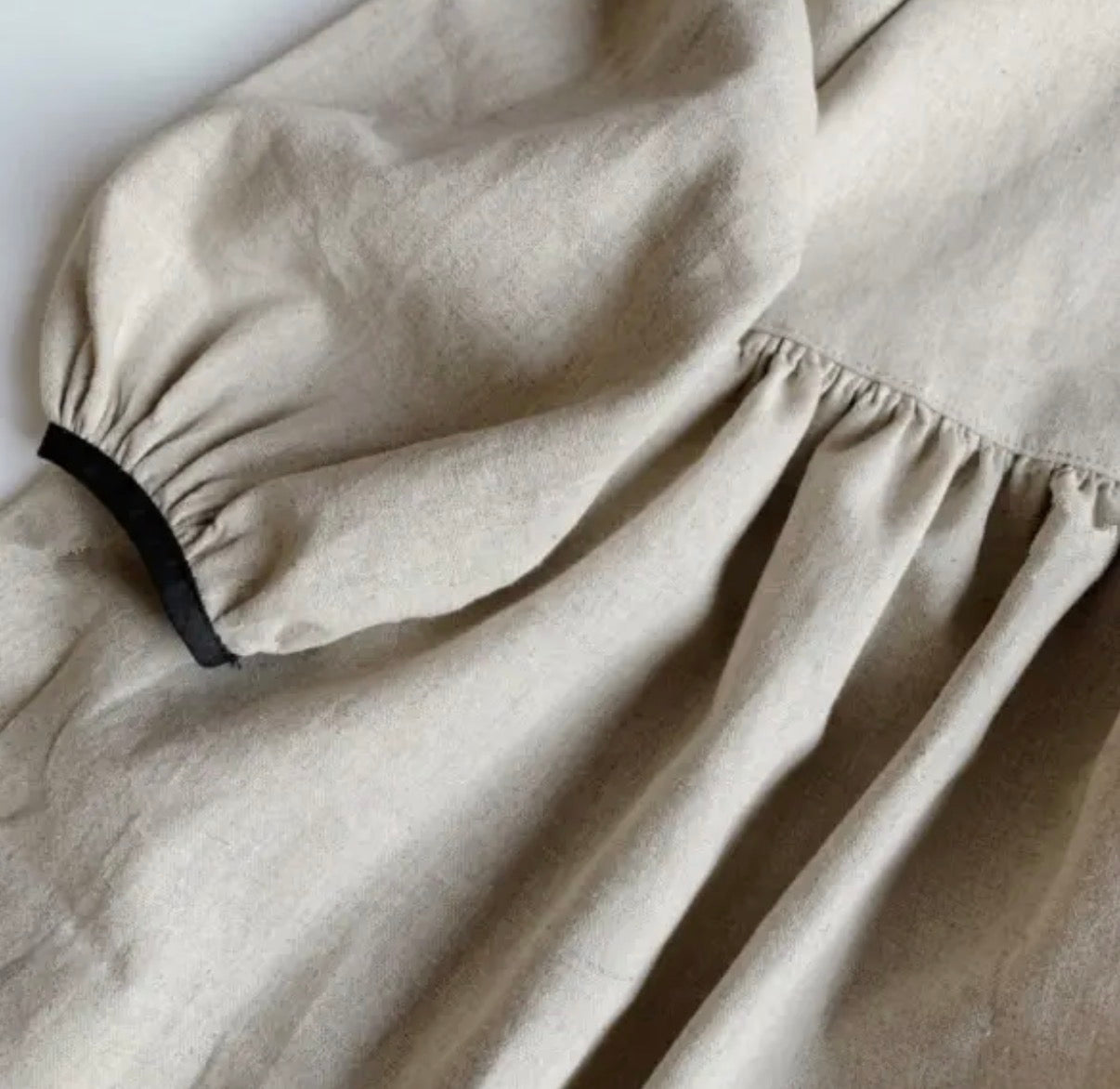 Vanilla bean linen dress for baby girls close up fabric detail