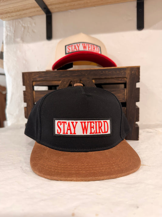 Stay Weird black and tan flat brim kids hat with faux suede brim and embroidered Stay Weird patch front view