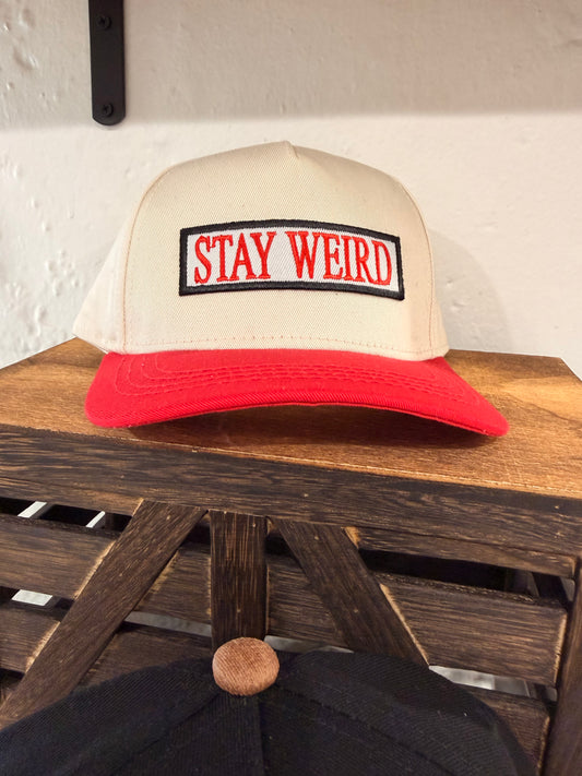 Stay Weird cream and red snapback kids hat with bold embroidered Stay Weird patch front view