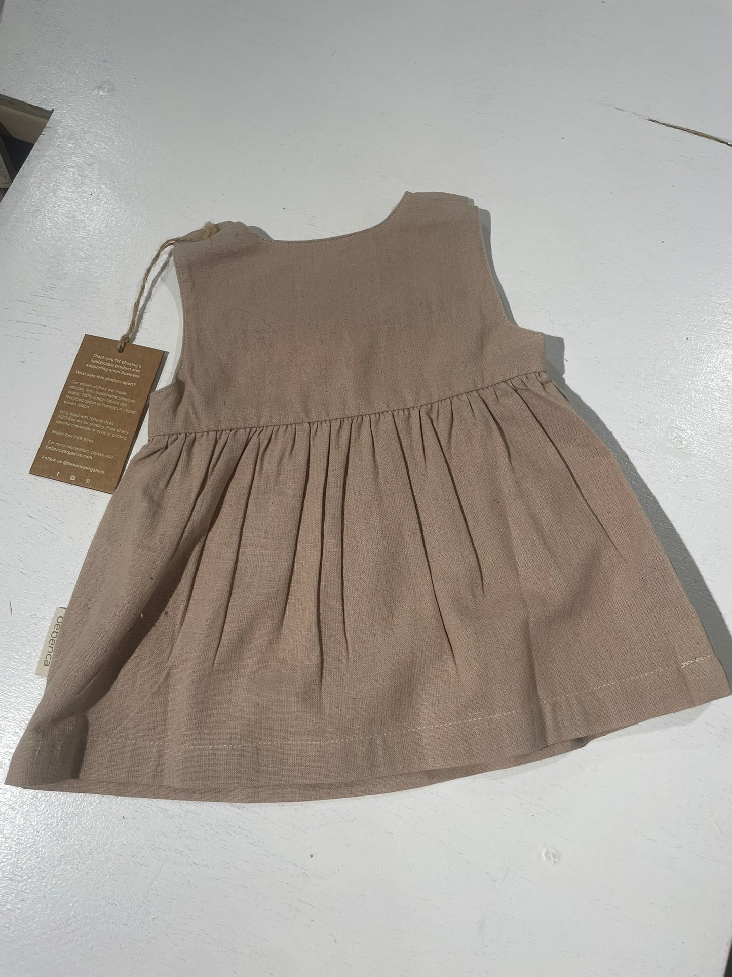 Brown dress with a tag on a white background