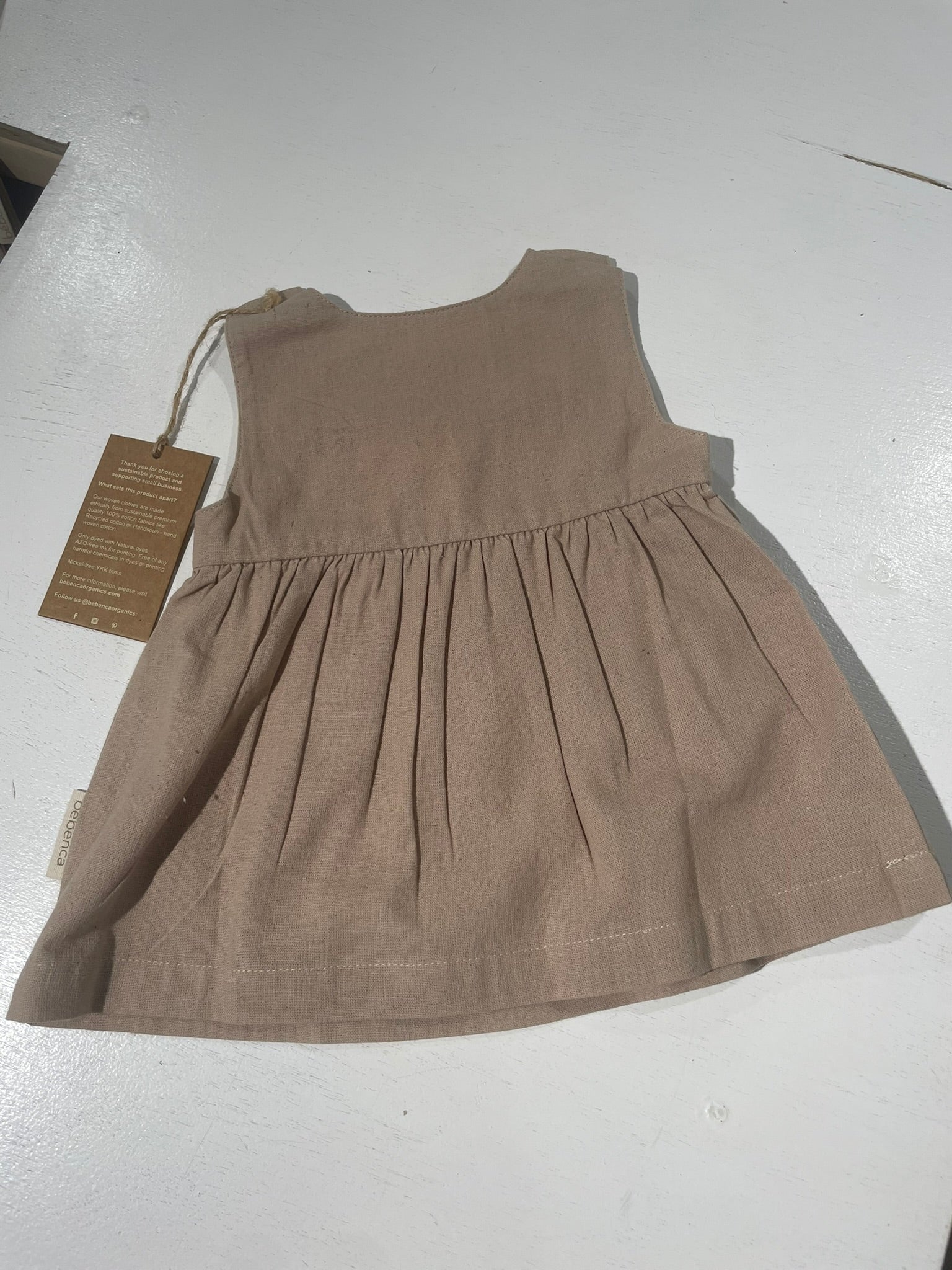 Brown dress with a tag on a white background