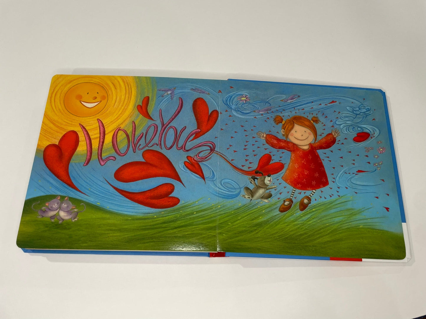 Colorful book cover with cartoon characters and hearts on a white background