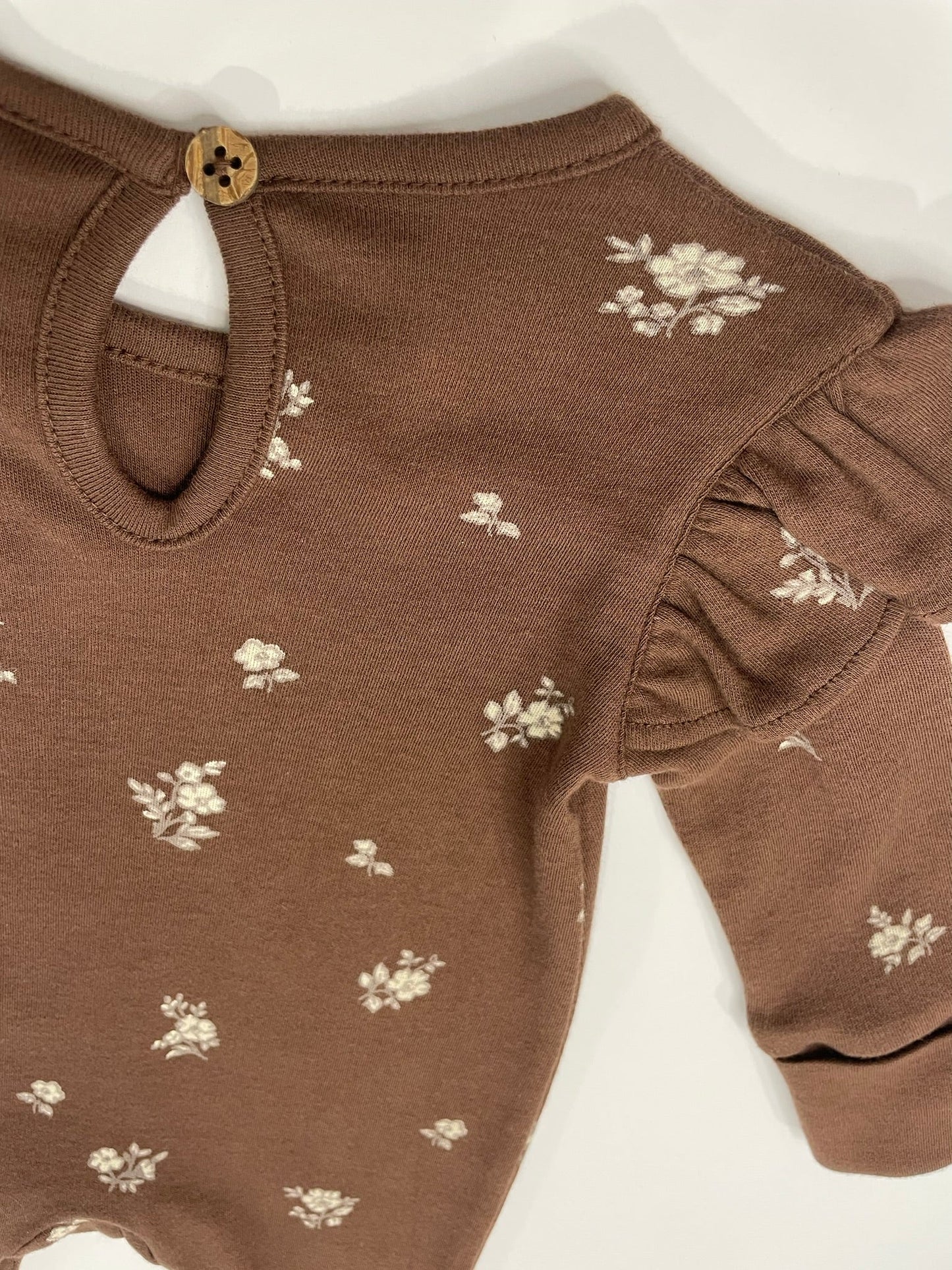 Organic ruffle sleeve romper flat lay product view