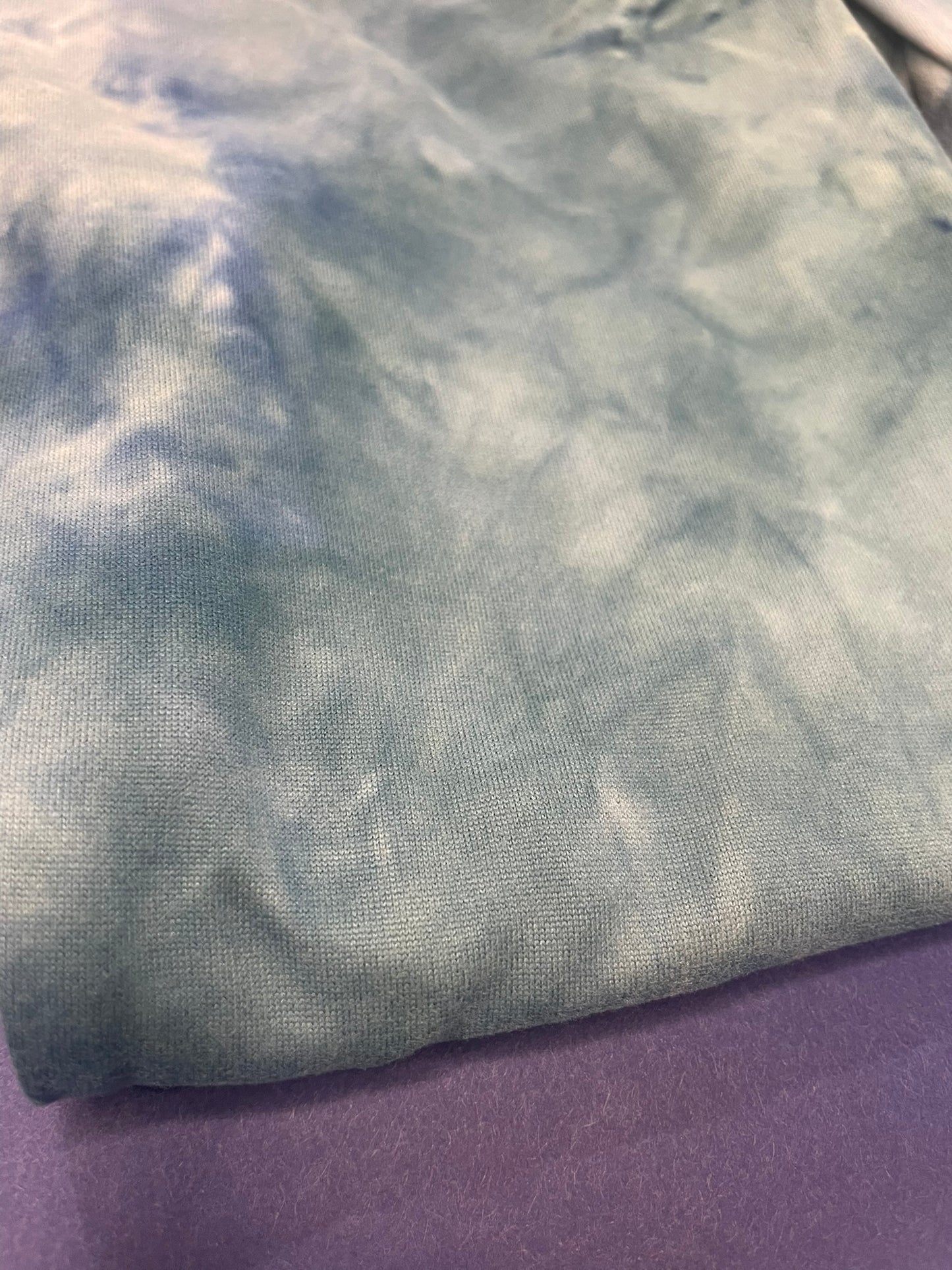 Handmade teal tie-dye kids jogger pants fabric close up view
