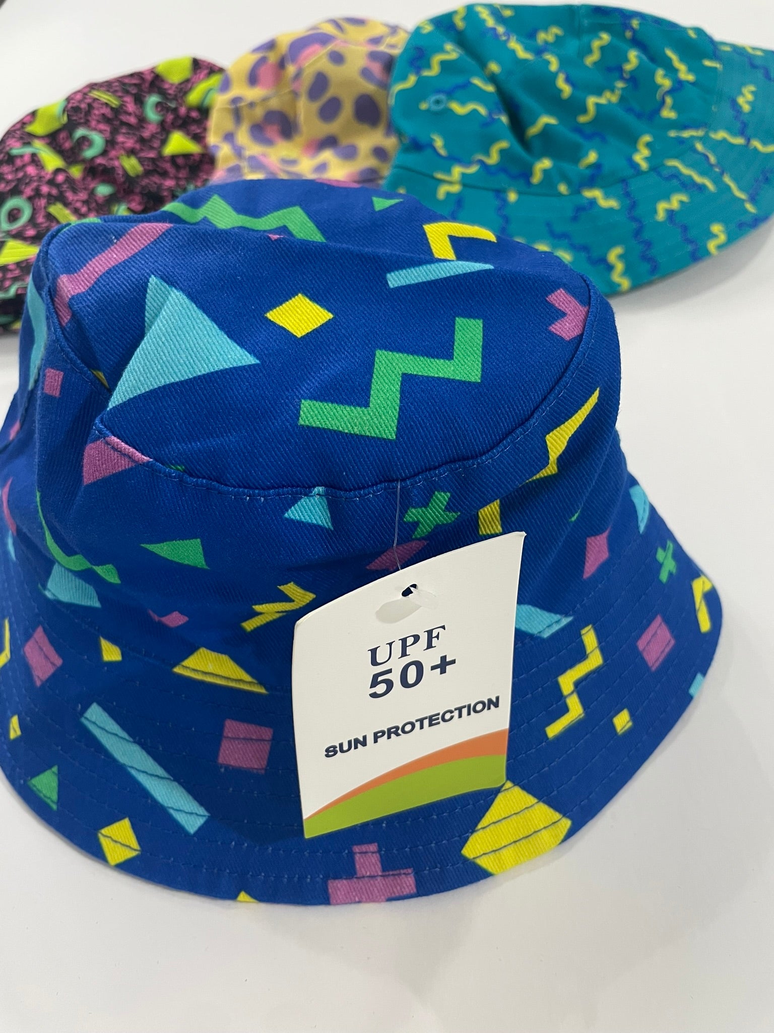 Blue 90s print bucket hat for kids flat lay product view