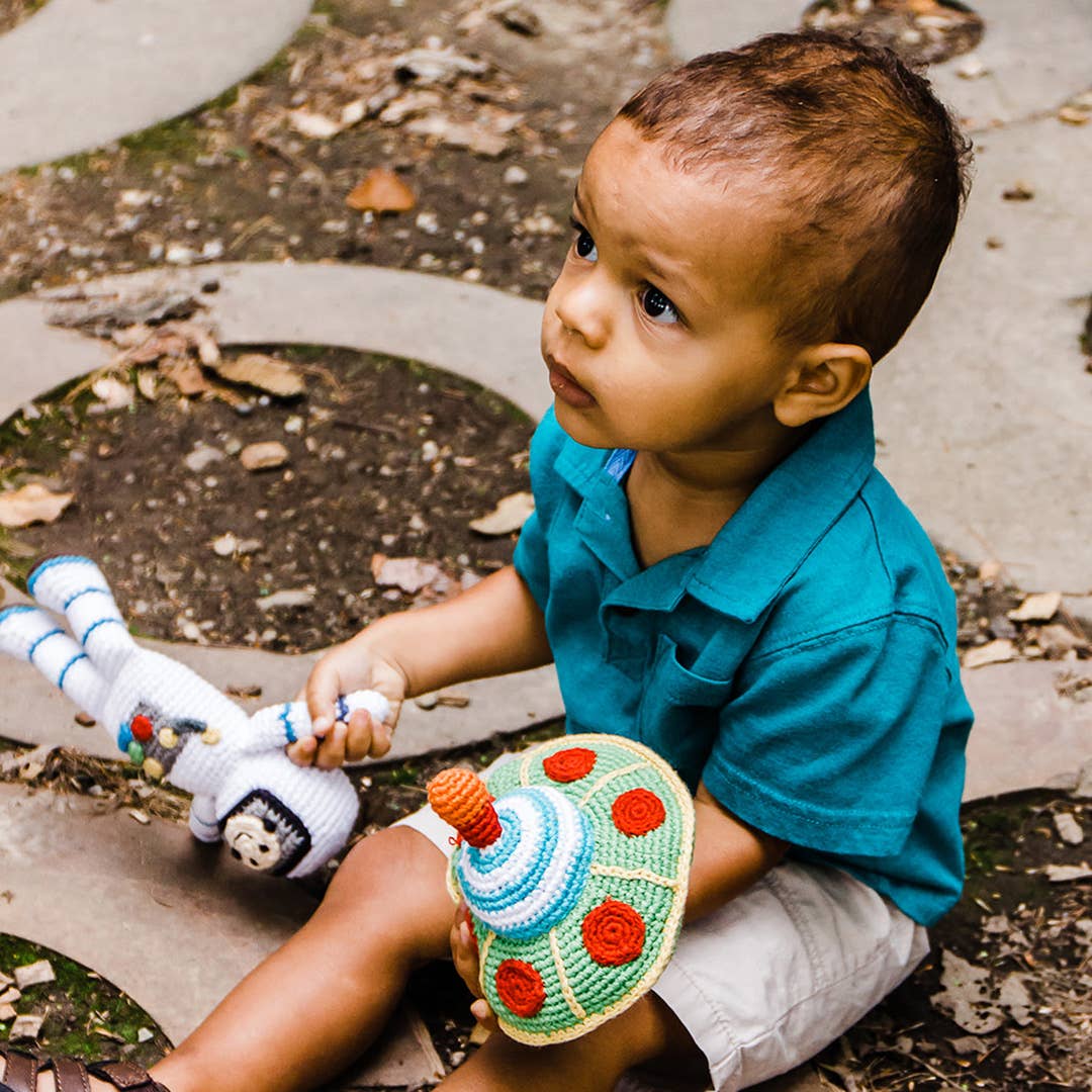 Baby astronaut rattle held lifestyle view