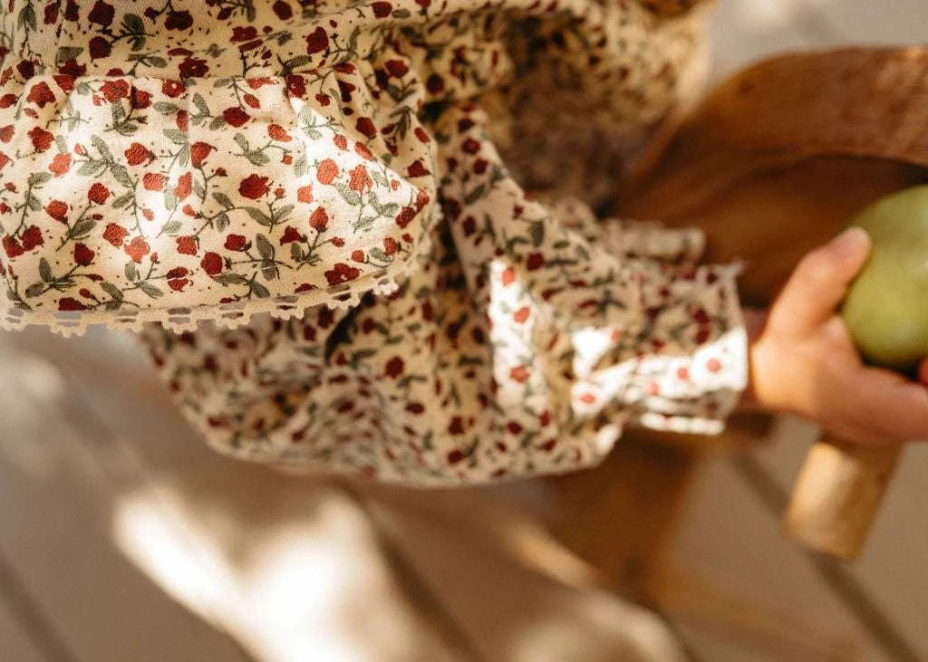 Baby Gloria floral romper worn lifestyle view