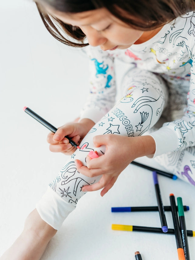 Kids unicorn coloring PJs with markers worn lifestyle view