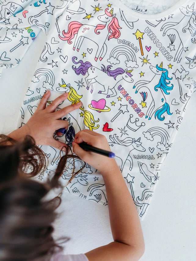 Unicorn coloring pajamas for kids flat lay with markers product view